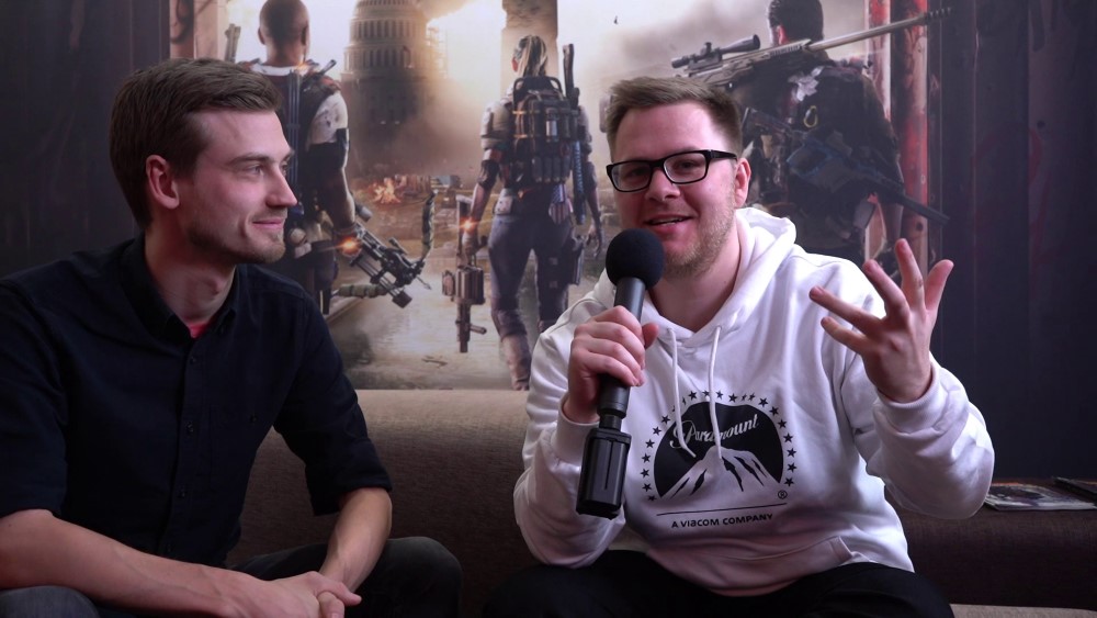 Still image of our host, Ben, interviewing Division 2 developer Mathias Karlson.